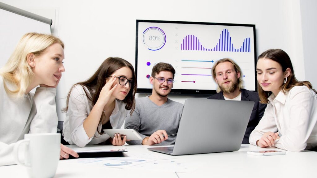 A diverse group of young professionals collaborating in a modern office environment.